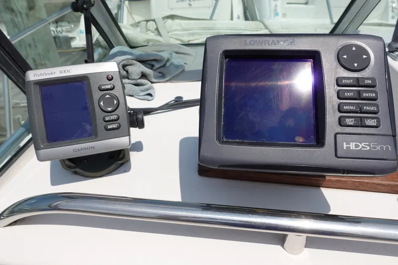 Slide: The Image of Garmin Fishfinder and Lowrance HDS5m on 1987 Grady-White Overnighter 206 boat dashboard. - 7