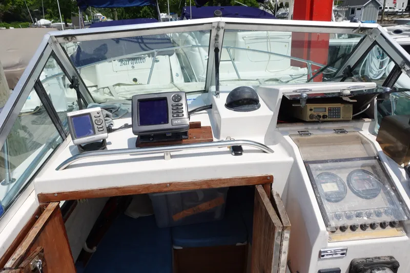 Slide: The Image of 1987 Grady-White Overnighter 206 boat dashboard with navigation equipment and gauges. - 5