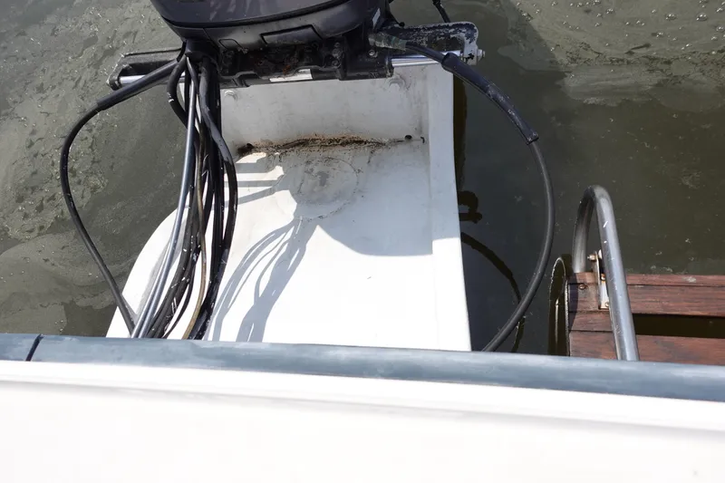 Slide: The Image of 1987 Grady-White Overnighter 206 boat engine and ladder detail. - 12