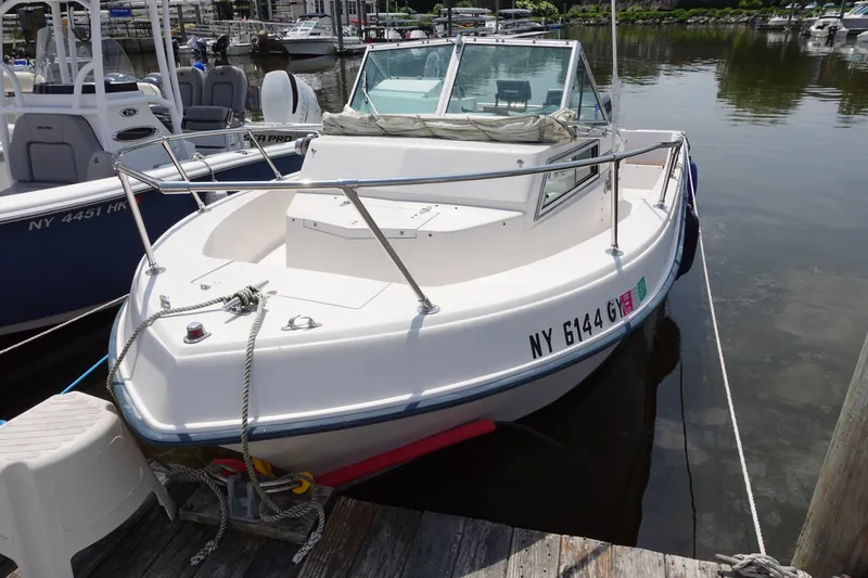 Slide: The Image of 1987 Grady-White Overnighter 206 boat docked at marina, front view. - 1