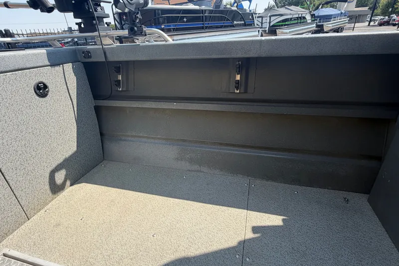 Slide: The Image of Interior view of a 2016 Weldcraft 220 Maverick DV boat, showcasing seating and storage area. - 27
