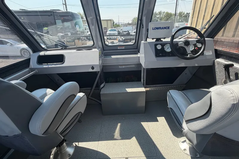 Slide: The Image of Interior of a 2016 Weldcraft 220 Maverick DV boat with steering console and seating. - 29