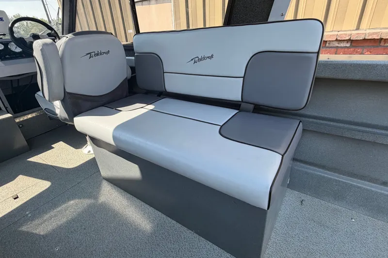 Slide: The Image of Interior seating of a 2016 Weldcraft 220 Maverick DV boat, featuring gray upholstery. - 31