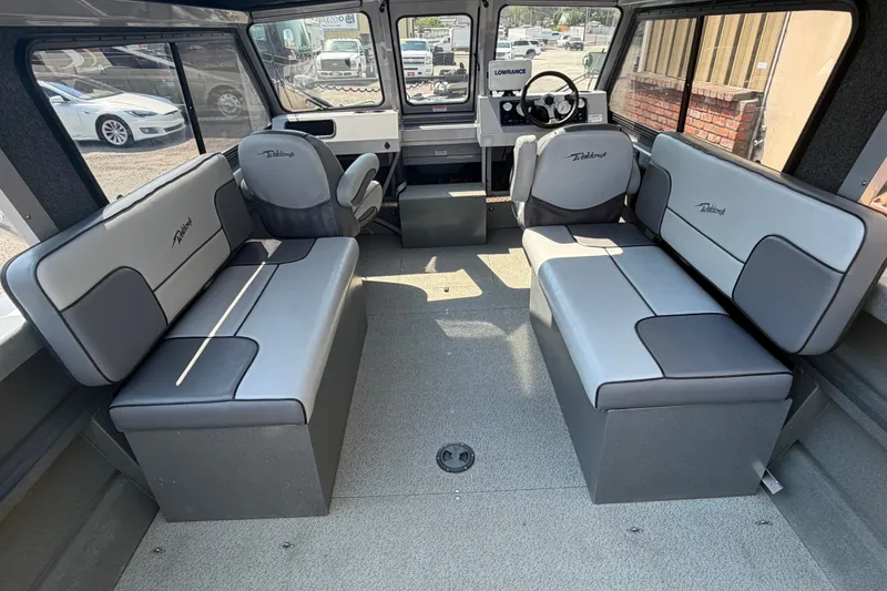 Slide: The Image of Interior of 2016 Weldcraft 220 Maverick DV boat with gray seating and steering console. - 22