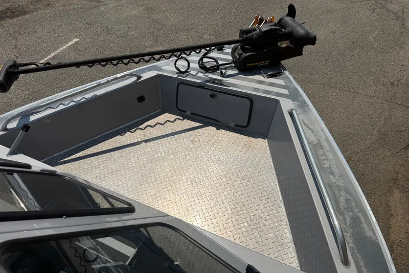 Slide: The Image of 2016 Weldcraft 220 Maverick DV boat deck with trolling motor and storage compartment. - 36