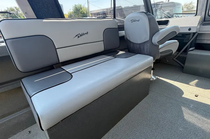 Slide: The Image of Interior seating of 2016 Weldcraft 220 Maverick DV boat, featuring gray and black upholstery. - 28