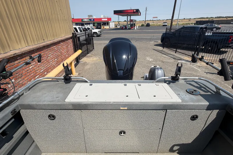Slide: The Image of 2016 Weldcraft 220 Maverick DV boat with motor, parked near a gas station. - 26