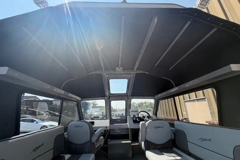 Slide: The Image of Interior of a 2016 Weldcraft 220 Maverick DV boat with seating and steering console. - 19