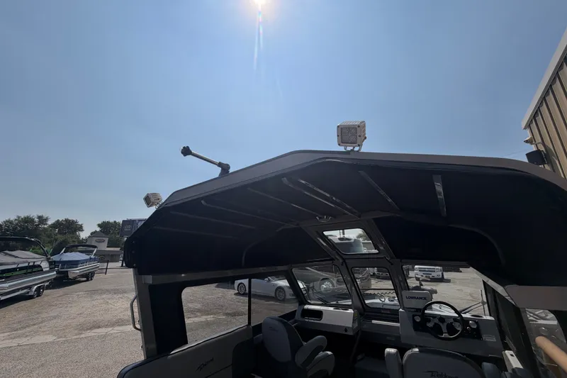 Slide: The Image of 2016 Weldcraft 220 Maverick DV boat interior under sunny sky at a dealership. - 21