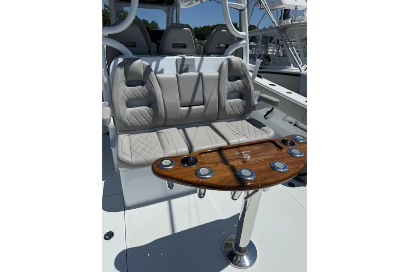 Slide: The Image of Luxurious seating on 2026 Freeman 42LR boat with elegant wood accents and cup holders. - 16