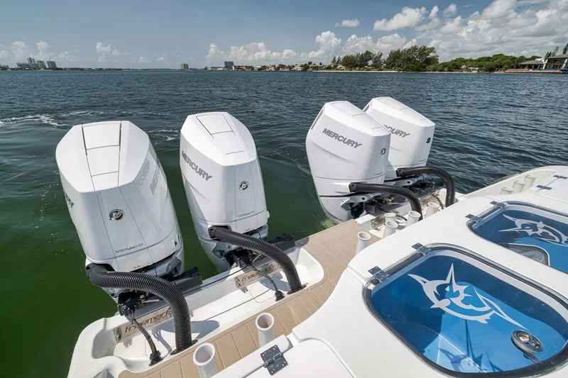 Slide: The Image of Freeman 42LR 2026 boat with four Mercury outboard engines on open water. - 82