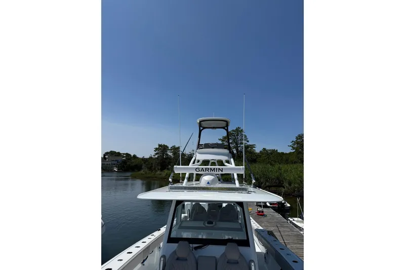 Slide: The Image of 2026 Freeman 42LR boat docked, featuring Garmin equipment under a clear blue sky. - 20