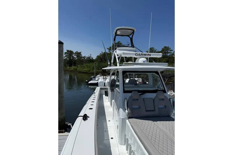 Slide: The Image of 2026 Freeman 42LR boat docked, featuring Garmin equipment under clear blue sky. - 18