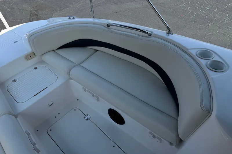 Slide: The Image of 2004 Chaparral Sunesta 212 boat interior with white seating and cup holders. - 15