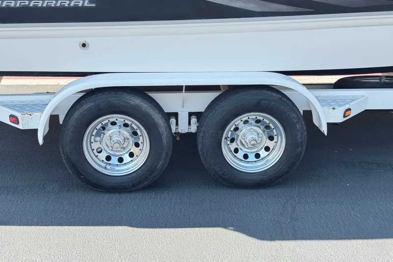 Slide: The Image of Trailer wheels of a 2004 Chaparral Sunesta 212 boat on pavement. - 31
