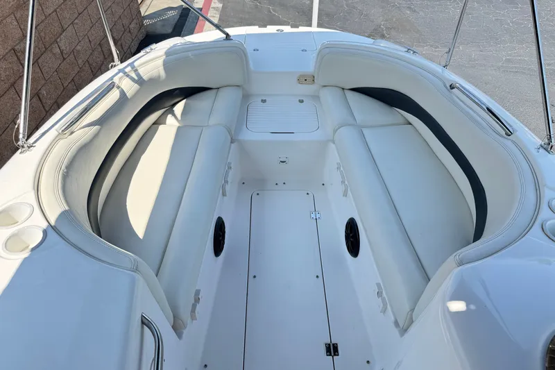 Slide: The Image of 2004 Chaparral Sunesta 212 boat interior with white seating and cup holders. - 13