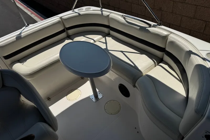 Slide: The Image of 2004 Chaparral Sunesta 212 boat interior with white seating and round table. - 22