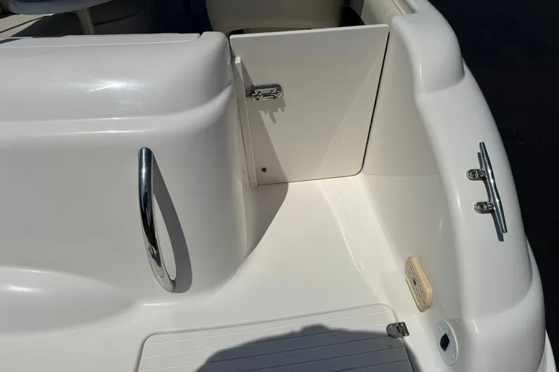 Slide: The Image of 2004 Chaparral Sunesta 212 boat interior, featuring sleek white design and chrome accents. - 7