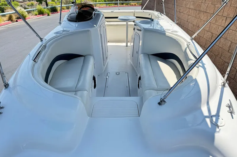 Slide: The Image of 2004 Chaparral Sunesta 212 boat interior with white seating and sleek design. - 12