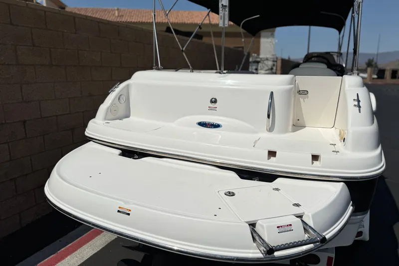 Slide: The Image of 2004 Chaparral Sunesta 212 boat, rear view with swim platform and ladder. - 6