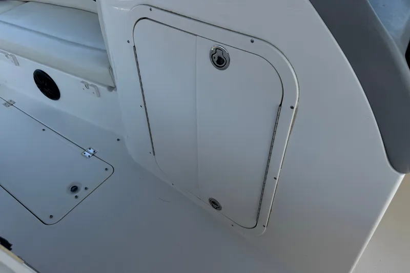 Slide: The Image of 2004 Chaparral Sunesta 212 boat interior, featuring storage compartment and seating area. - 29