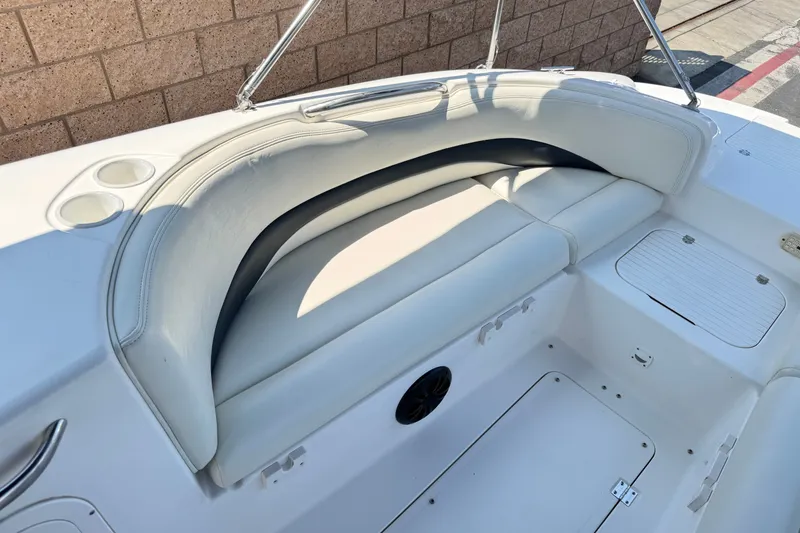 Slide: The Image of 2004 Chaparral Sunesta 212 boat interior with white seating and cup holders. - 14