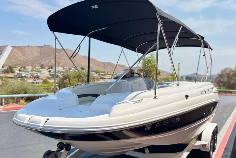 Slide: The Image of 2004 Chaparral Sunesta 212 boat with canopy on trailer, scenic background. - 3