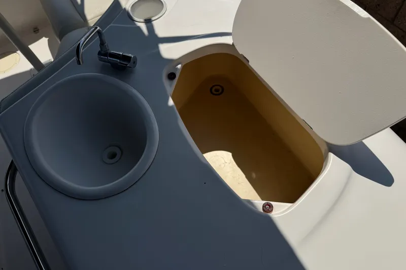 Slide: The Image of 2004 Chaparral Sunesta 212 boat sink and storage compartment detail. - 20
