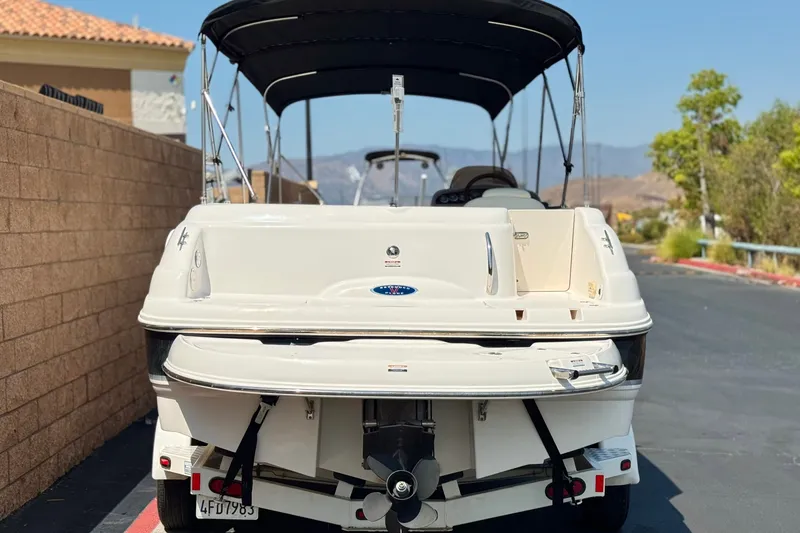 Slide: The Image of 2004 Chaparral Sunesta 212 boat, rear view, parked on a sunny street. - 5