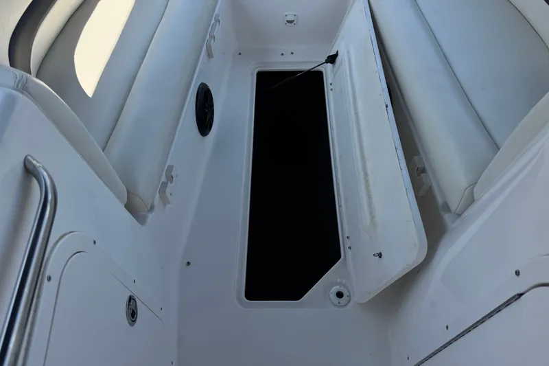 Slide: The Image of Open storage compartment on a 2004 Chaparral Sunesta 212 boat interior. - 17