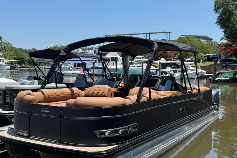 The Image of 2027 Avalon Excalibur Quad Lounge pontoon boat docked, featuring luxurious seating and sleek design. - 1