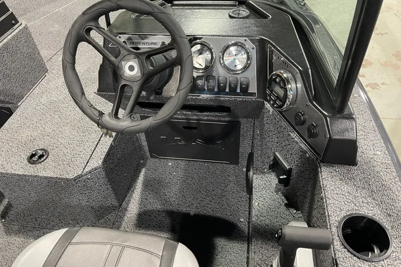 Slide: The Image of Interior of 2027 Lund 1700 Adventure Sport boat with steering wheel and dashboard controls. - 18