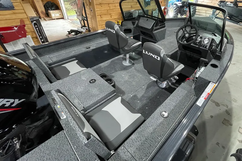 The Image of 2027 Lund 1700 Adventure Sport boat interior with seating and steering console. - 0
