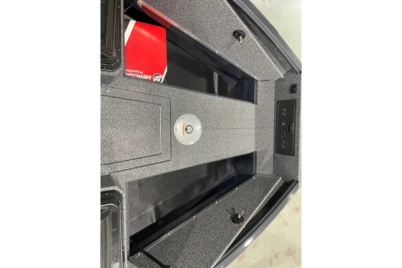 Slide: The Image of Interior view of 2027 Lund 1700 Adventure Sport boat, featuring storage compartments and carpeted flooring. - 16