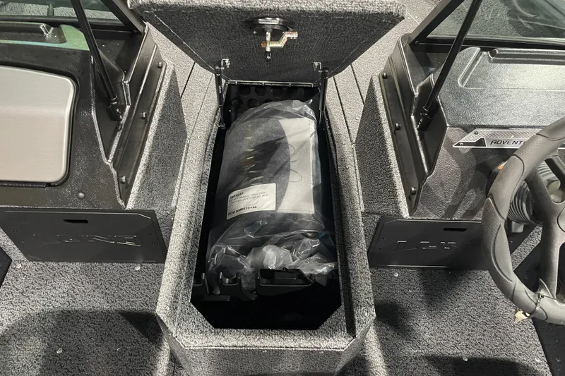 Slide: The Image of 2027 Lund 1700 Adventure Sport boat interior with storage compartment open. - 17