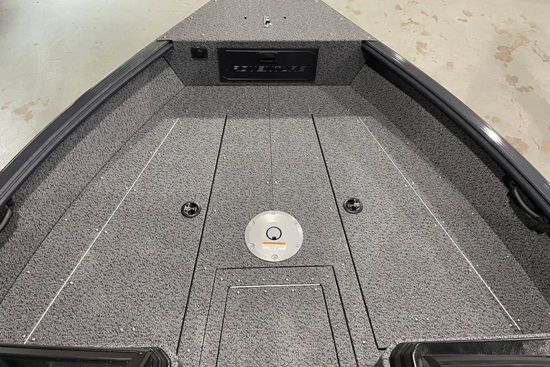 Slide: The Image of 2027 Lund 1700 Adventure Sport boat interior with gray carpeted deck and storage compartments. - 15