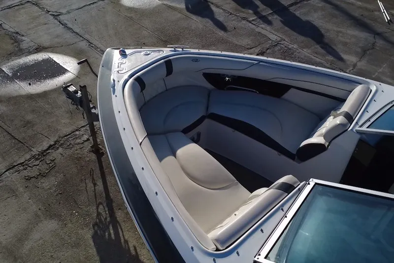 Slide: The Image of 2018 Regal 2300 Bowrider boat with spacious seating on a concrete surface. - 12