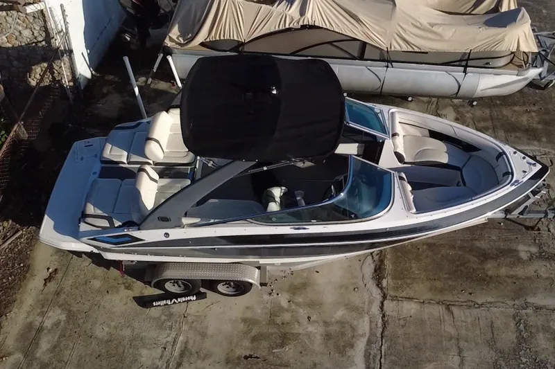 Slide: The Image of 2018 Regal 2300 Bowrider boat on trailer, aerial view, parked outdoors. - 3
