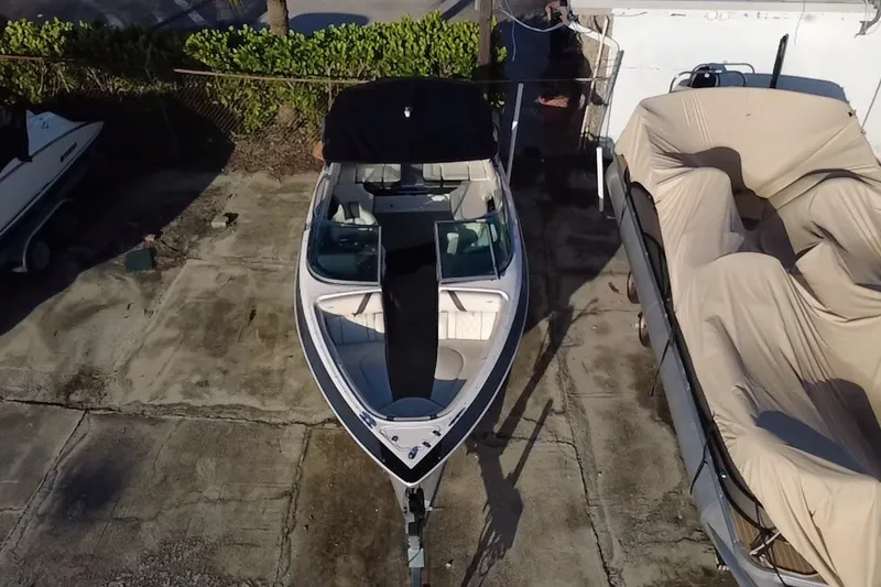 Slide: The Image of 2018 Regal 2300 Bowrider boat parked on concrete, aerial view. - 9
