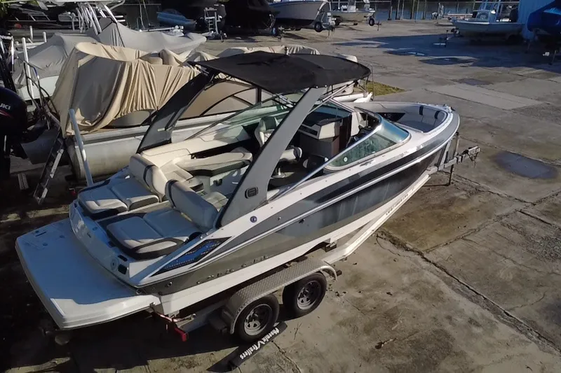 Slide: The Image of 2018 Regal 2300 Bowrider boat on trailer, parked in marina lot. - 2