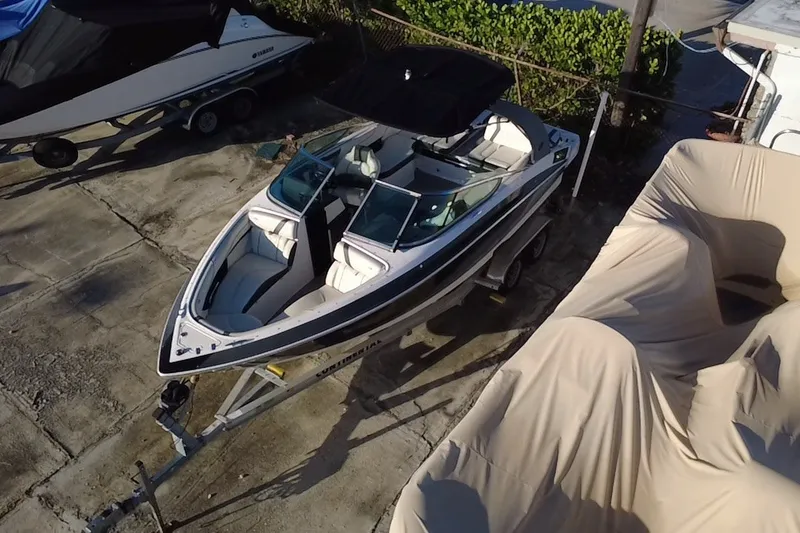 Slide: The Image of 2018 Regal 2300 Bowrider boat on trailer, parked outdoors. - 6