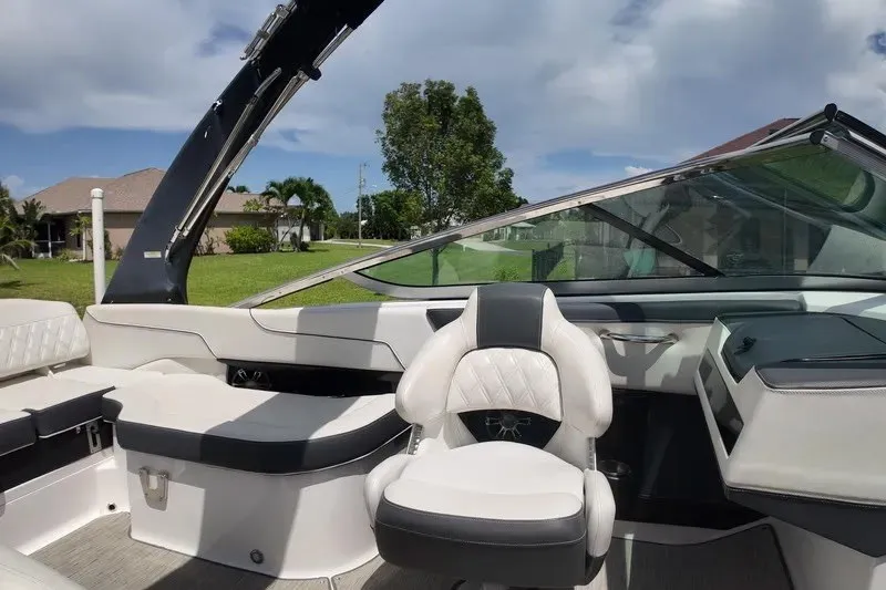 Slide: The Image of 2018 Regal 2300 Bowrider interior with white seating and sleek design. - 18