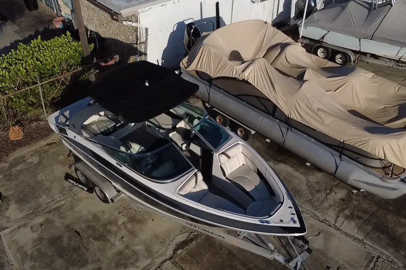 Slide: The Image of 2018 Regal 2300 Bowrider boat on trailer, aerial view, parked outdoors. - 4