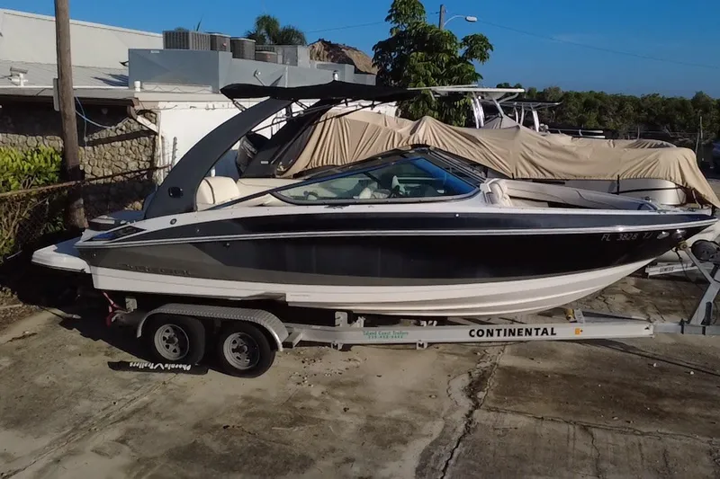 Slide: The Image of 2018 Regal 2300 Bowrider boat on trailer, parked outdoors. - 1