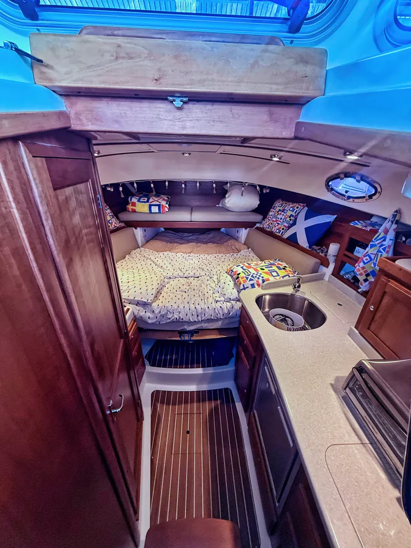 Slide: The Image of Interior of a 2016 Back Cove 30 with cozy bed and kitchenette. - 14