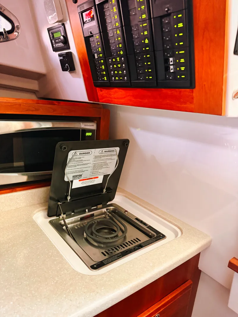 Slide: The Image of Interior of a 2016 Back Cove 30 featuring a stove and control panel. - 25