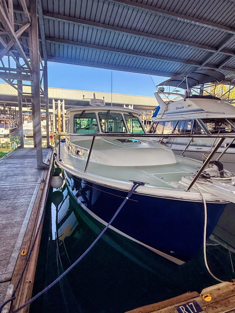 Slide: The Image of A 2016 Back Cove 30 boat docked in a covered marina. - 28