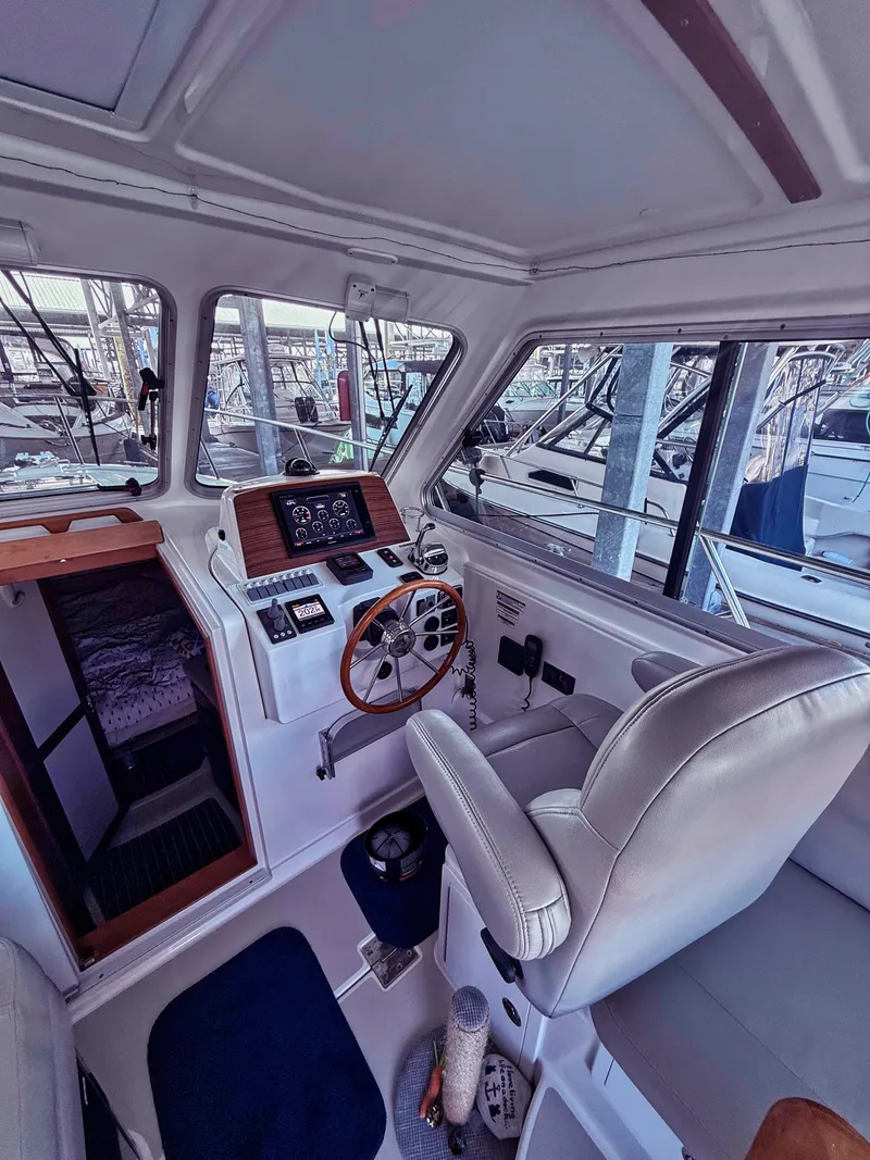 Slide: The Image of Interior of a 2016 Back Cove 30 with steering wheel and navigation system. - 13