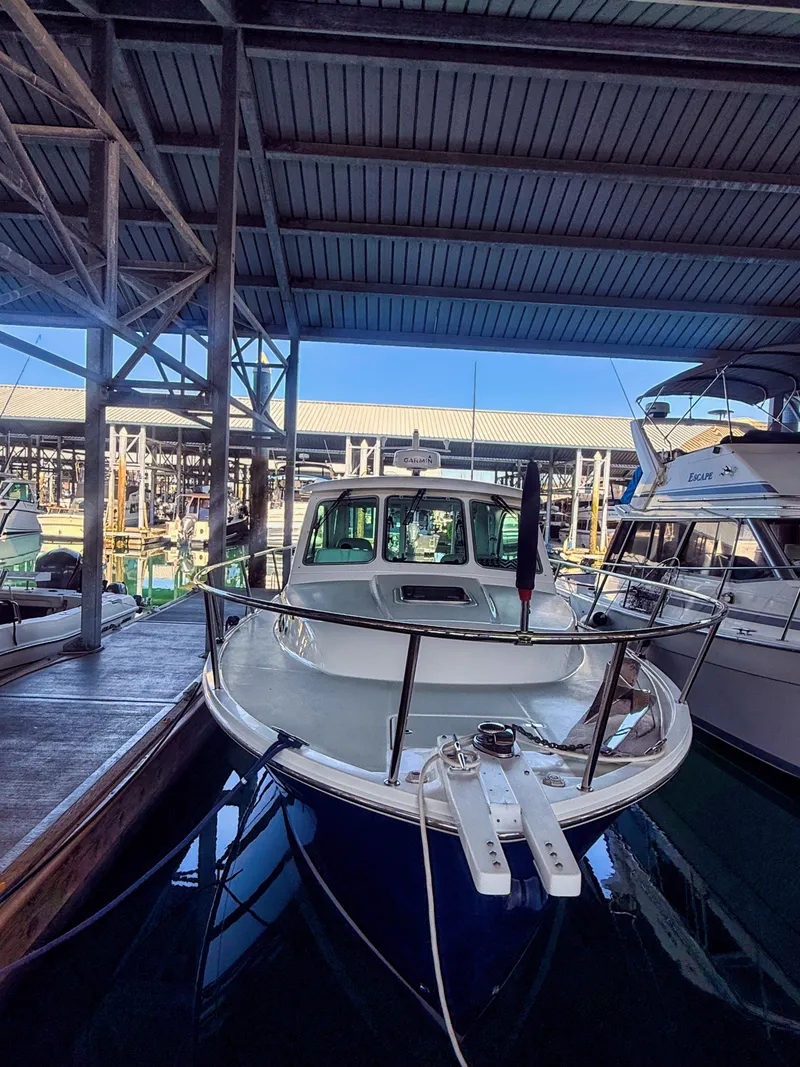 Slide: The Image of A 2016 Back Cove 30 boat docked in a covered marina. - 29