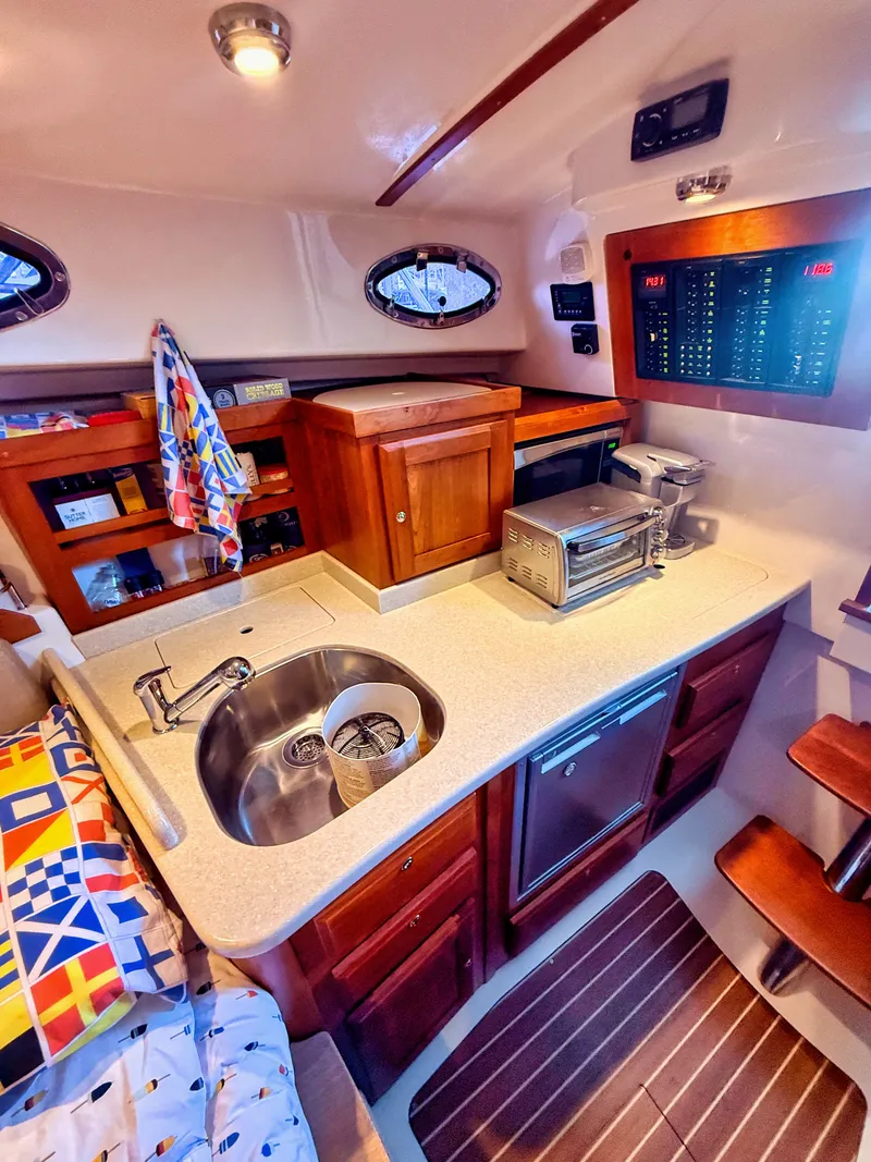 Slide: The Image of Interior of a 2016 Back Cove 30 featuring a well-equipped galley. - 18